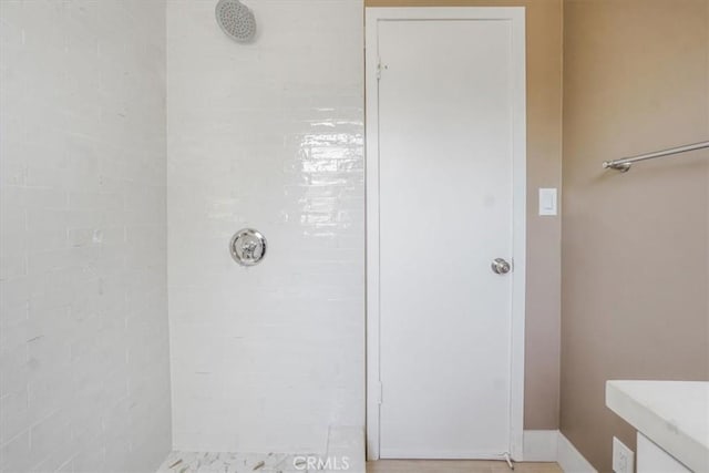 bathroom with vanity and tiled shower