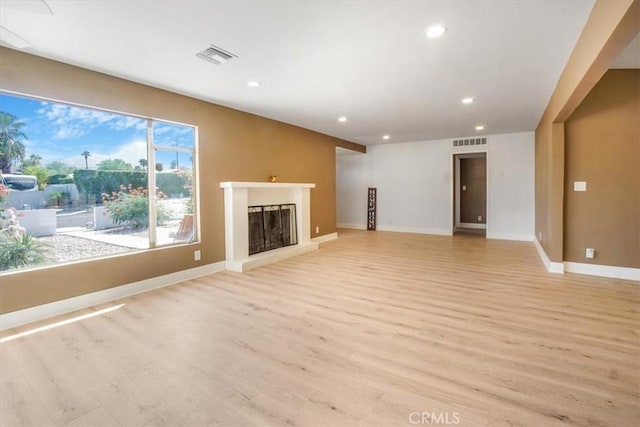 unfurnished living room with light hardwood / wood-style flooring