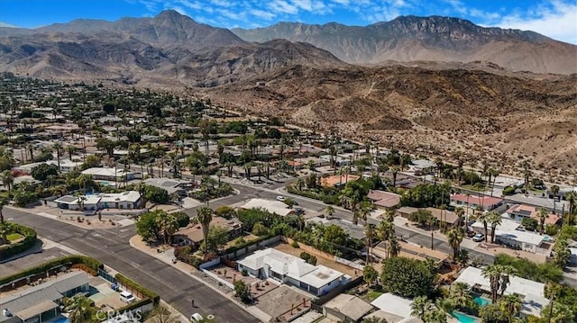 birds eye view of property with a mountain view