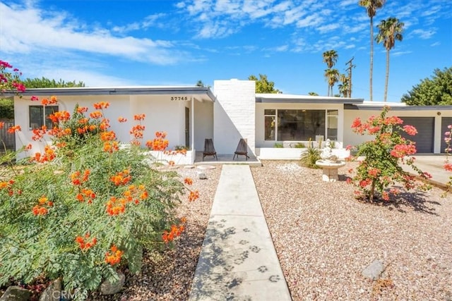 ranch-style house featuring a garage