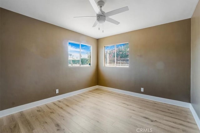 spare room with ceiling fan and light hardwood / wood-style flooring