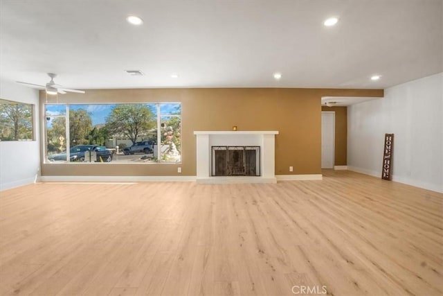 unfurnished living room with ceiling fan and light wood-type flooring