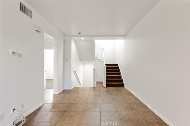 stairway with tile patterned floors