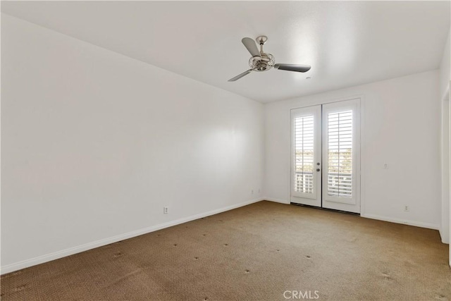 carpeted spare room featuring french doors and ceiling fan