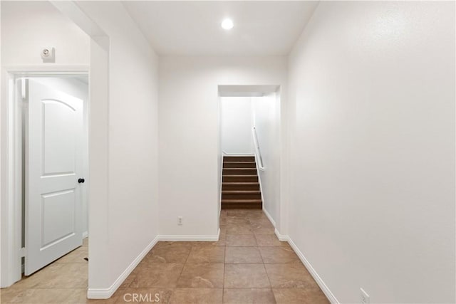 hall featuring light tile patterned floors