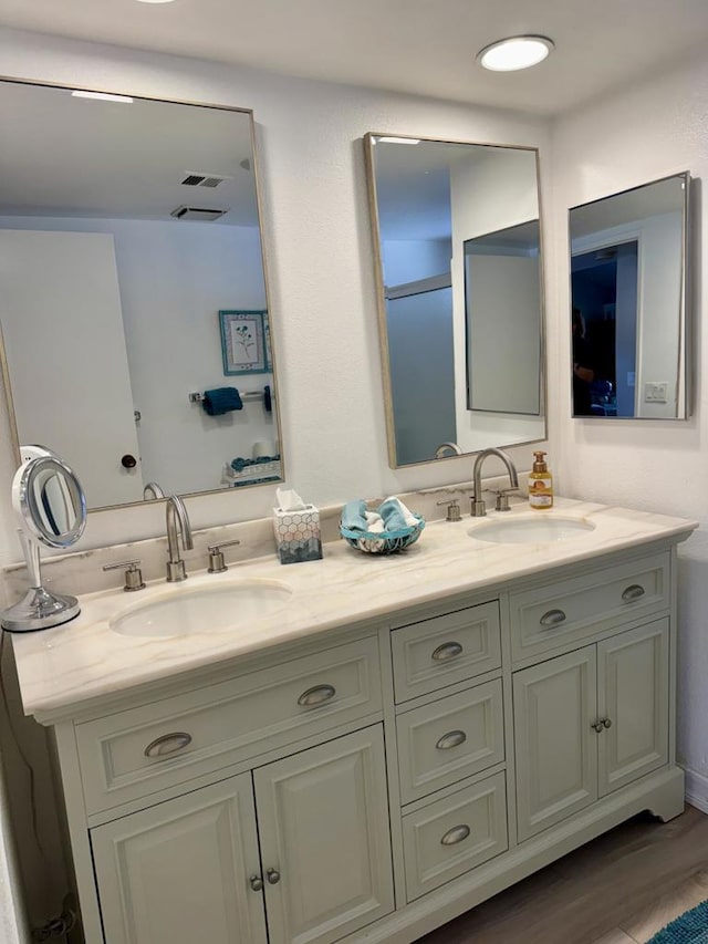 bathroom with vanity and hardwood / wood-style floors