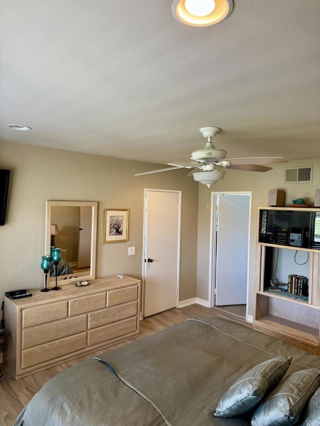 bedroom with ceiling fan and light hardwood / wood-style flooring