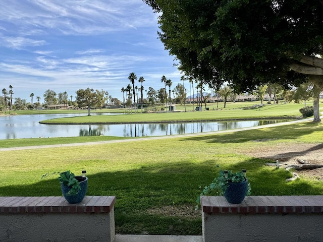 exterior space featuring a water view and a lawn