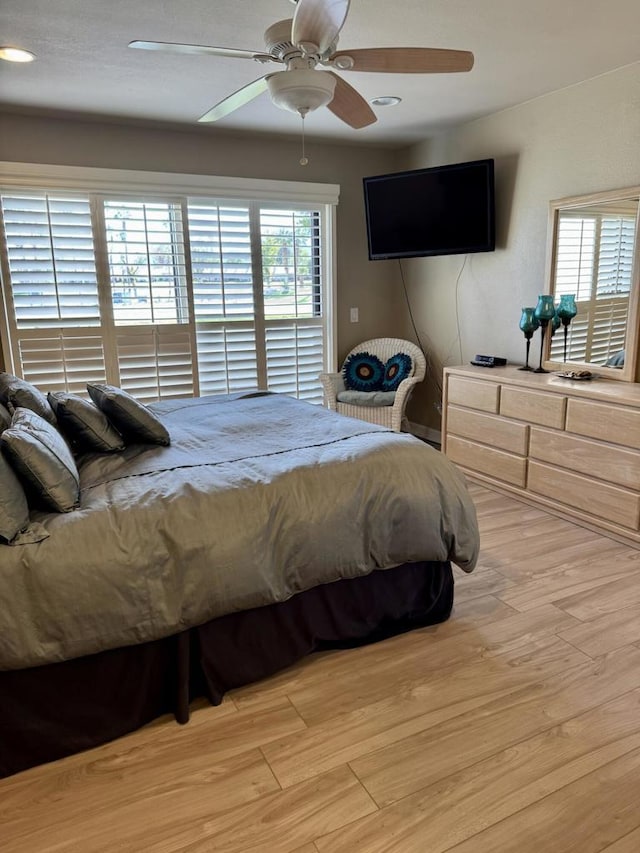 bedroom featuring ceiling fan and light hardwood / wood-style floors