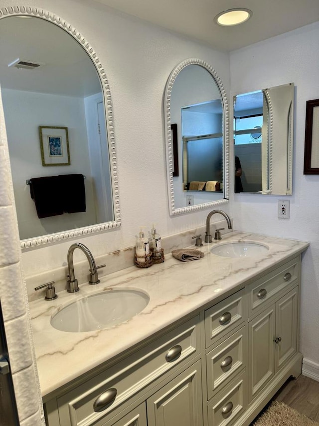 bathroom featuring hardwood / wood-style flooring and vanity