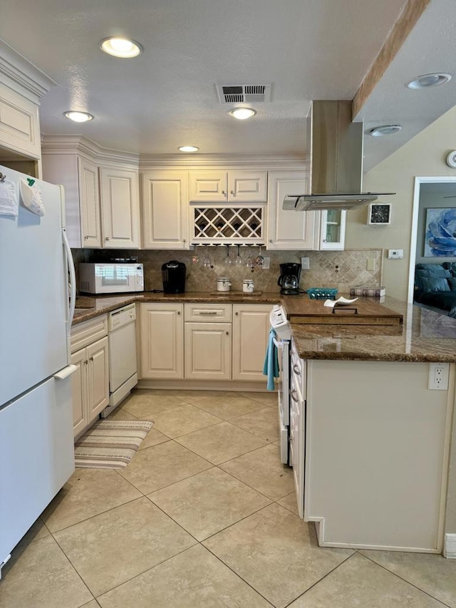 kitchen featuring kitchen peninsula, island exhaust hood, white appliances, light tile patterned flooring, and white cabinets