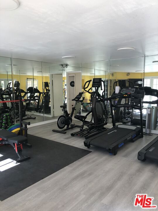 workout area with wood-type flooring