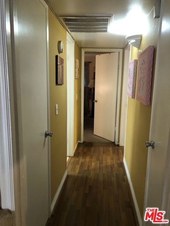 hallway featuring dark hardwood / wood-style flooring