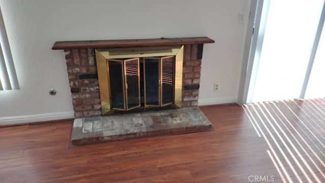 details with hardwood / wood-style floors and a fireplace