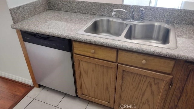 kitchen with dishwasher, light tile patterned flooring, and sink