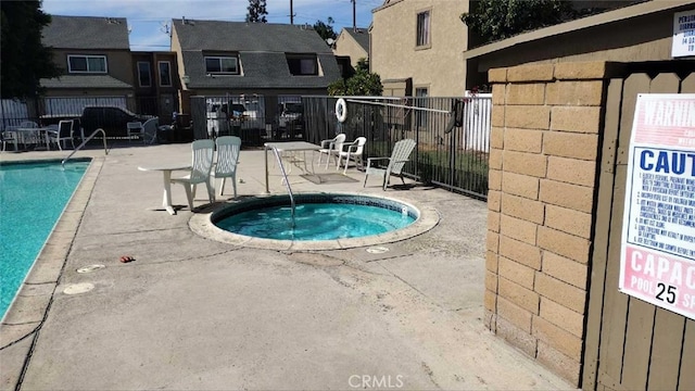 view of pool featuring a patio area and a hot tub