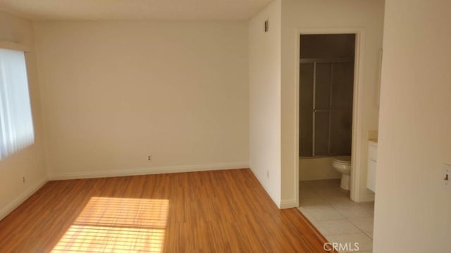 spare room featuring light hardwood / wood-style flooring