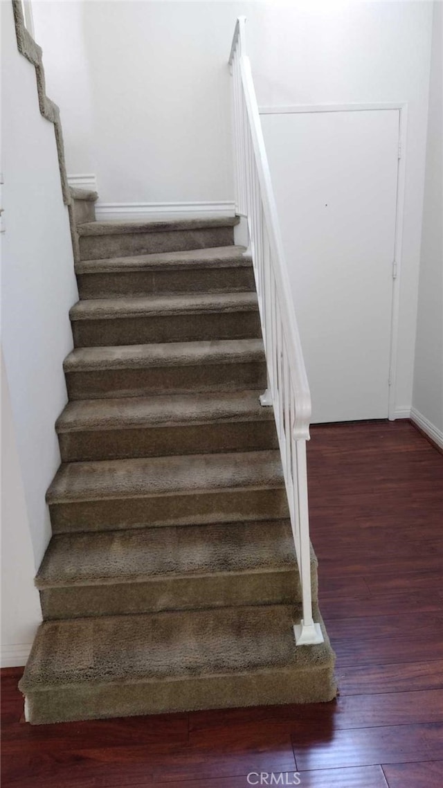 stairs with wood-type flooring