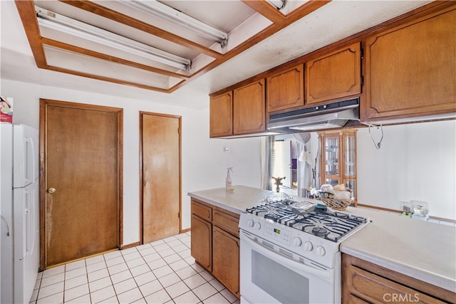 kitchen with white appliances and light tile patterned floors