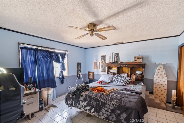 bedroom with crown molding, a textured ceiling, light tile patterned floors, and ceiling fan