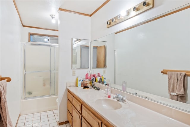 bathroom with vanity, combined bath / shower with glass door, ornamental molding, and tile patterned floors