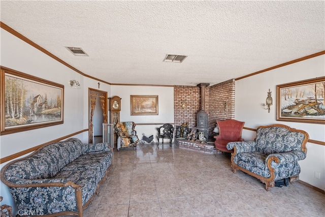 living room featuring light tile patterned floors, a wood stove, a textured ceiling, and ornamental molding