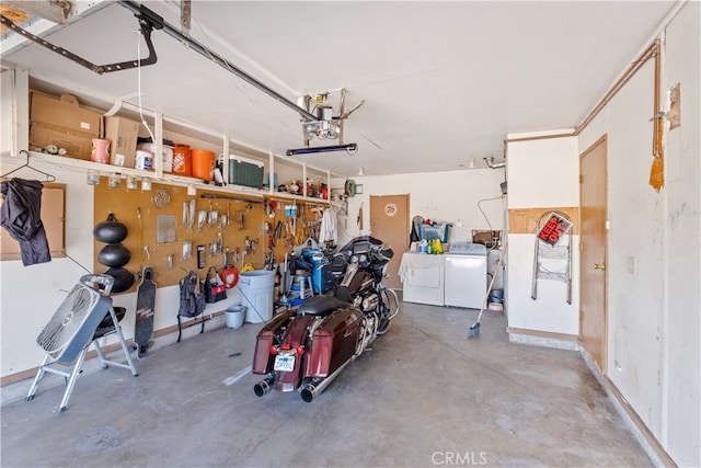 garage featuring washing machine and dryer and a workshop area