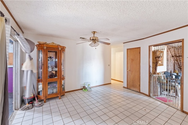 tiled empty room featuring a textured ceiling and ceiling fan