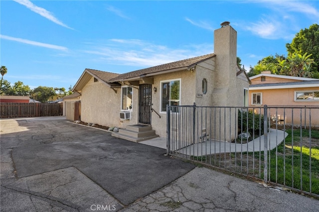 ranch-style home featuring cooling unit