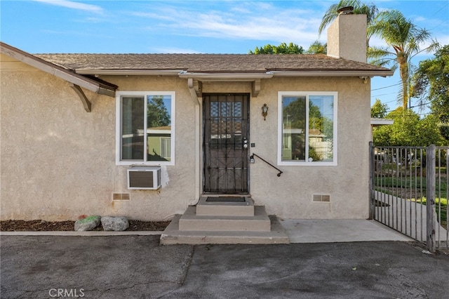 property entrance with a wall mounted AC