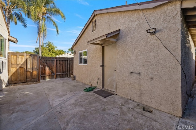 view of side of property with a patio