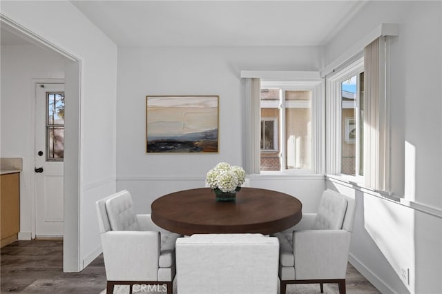 dining area with dark wood-type flooring and plenty of natural light