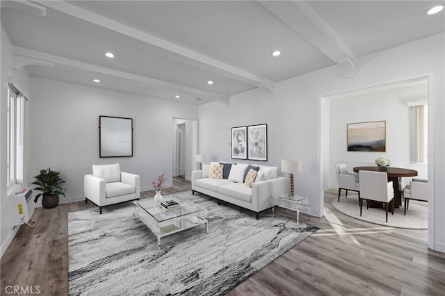 living room featuring beam ceiling and hardwood / wood-style flooring