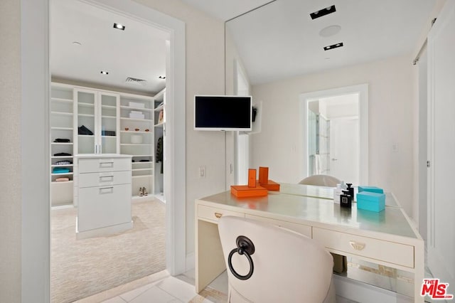 kitchen with light carpet and white cabinetry