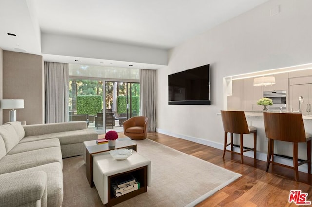 living room featuring a notable chandelier and hardwood / wood-style flooring