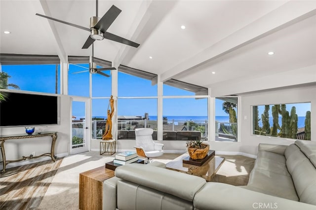 living room with a water view, ceiling fan, lofted ceiling with beams, and light carpet