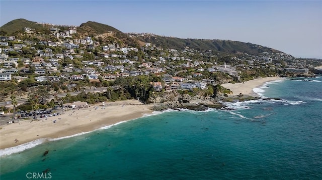 bird's eye view featuring a water and mountain view and a view of the beach