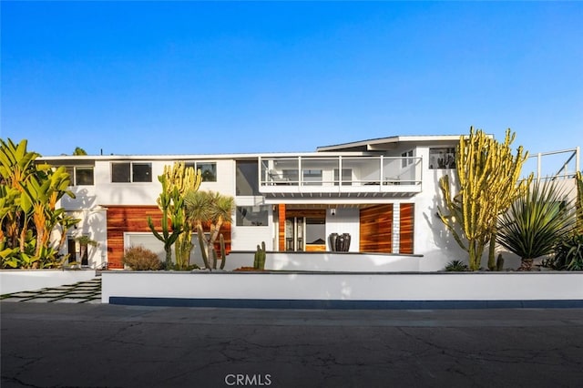 view of front of property with a balcony and a garage