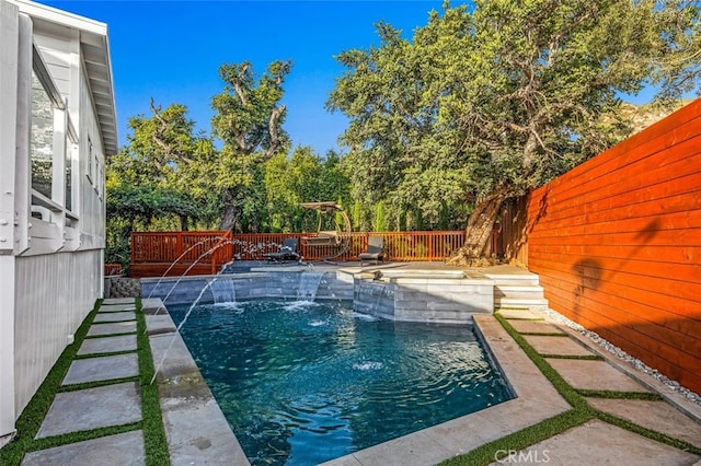 view of swimming pool with pool water feature