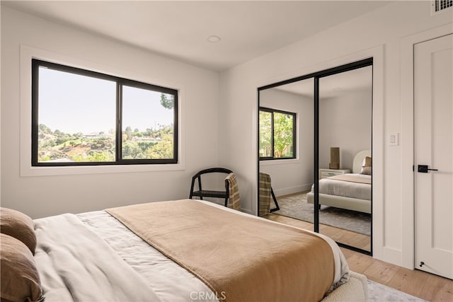 bedroom featuring light hardwood / wood-style floors and a closet