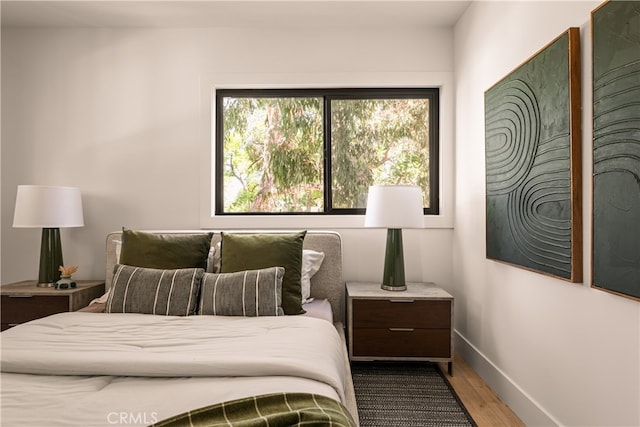 bedroom with wood-type flooring