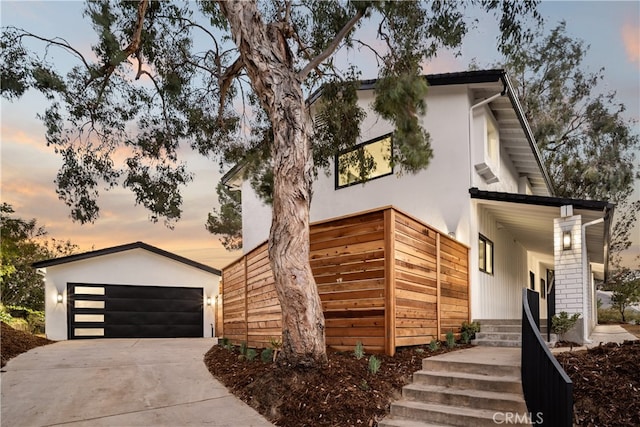 contemporary house featuring an outbuilding and a garage