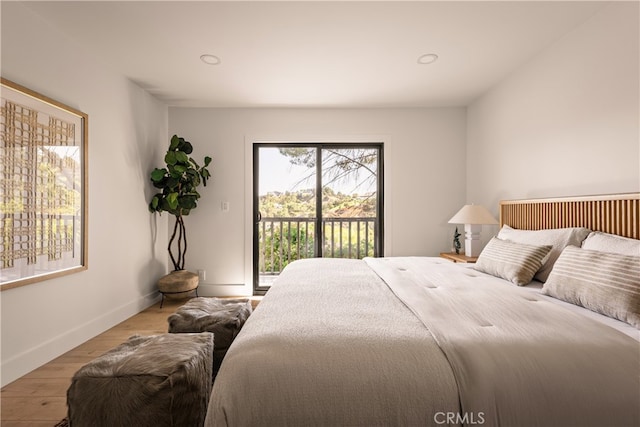 bedroom with light hardwood / wood-style floors and access to outside