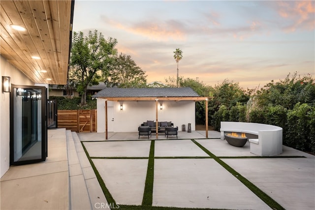 patio terrace at dusk featuring outdoor lounge area