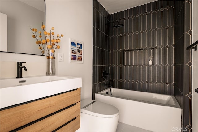 full bathroom featuring vanity, tiled shower / bath combo, and toilet