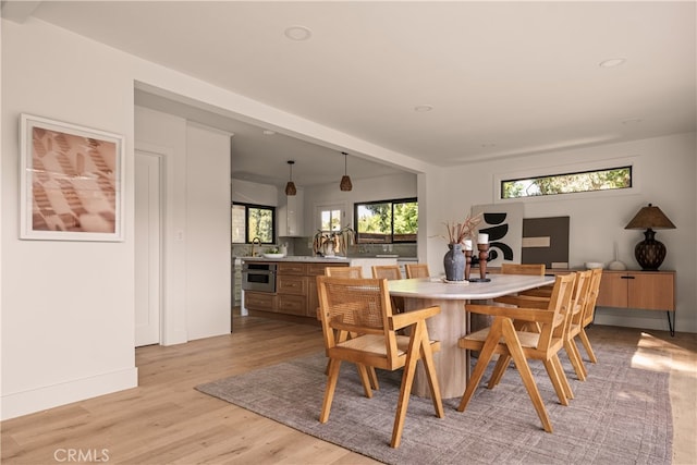 dining space with light hardwood / wood-style floors and a wealth of natural light