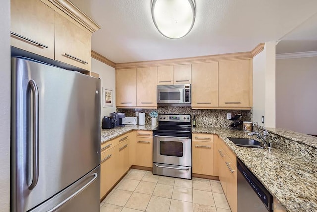 kitchen featuring appliances with stainless steel finishes, ornamental molding, sink, and light brown cabinetry