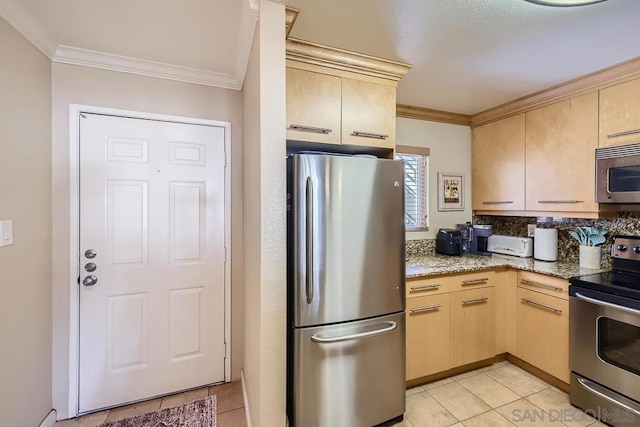 kitchen with light brown cabinetry, appliances with stainless steel finishes, ornamental molding, and light stone counters