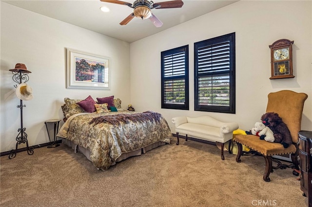 carpeted bedroom featuring baseboards and ceiling fan