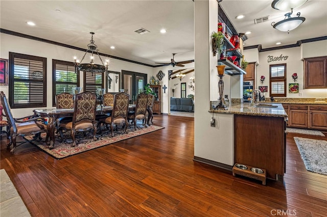 kitchen with a sink, visible vents, and dark wood-style flooring